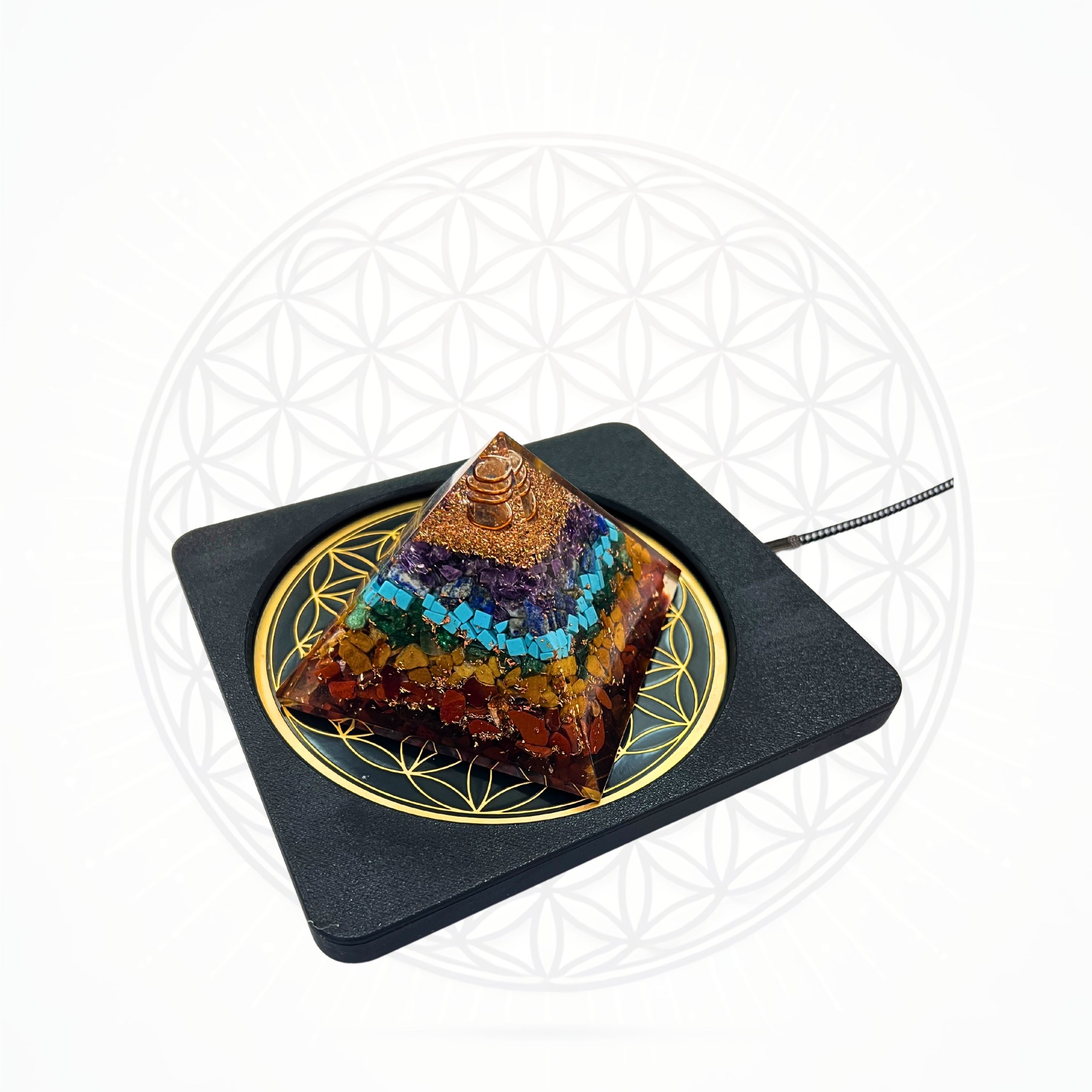 Sacred Ritual Oils Metatronic Flower of Life Frequency Imprinter pyramid with colorful stone layers on black base